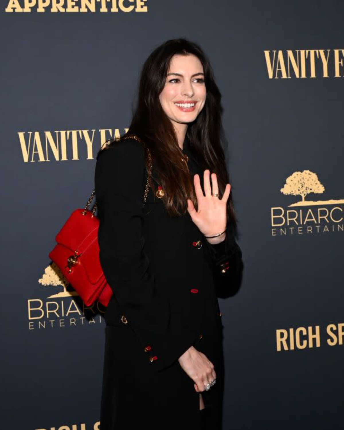 Cover Image for Anne Hathaway Plays With Proportions in a Leather Minidress and Floor-Length Gabardine Coat